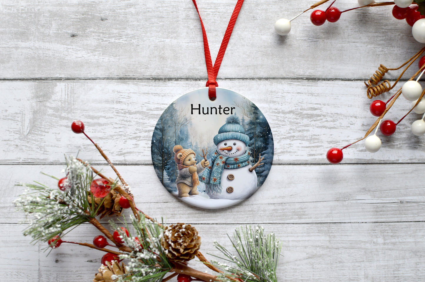 Teddy bear building a snowman personalised ceramic hanging bauble decoration image 0